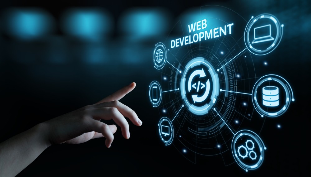 Hand reaching for digital web development icons on a futuristic interface.